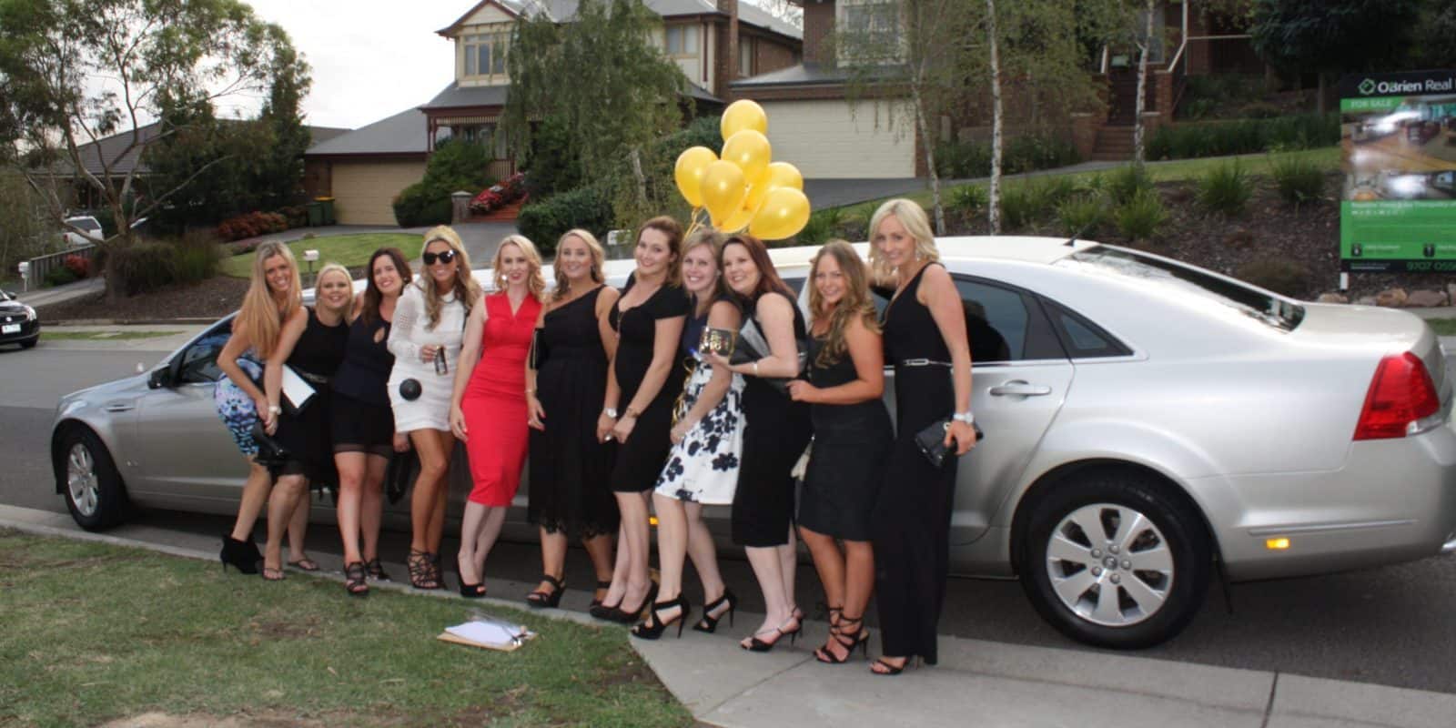 Group of women in front of limo